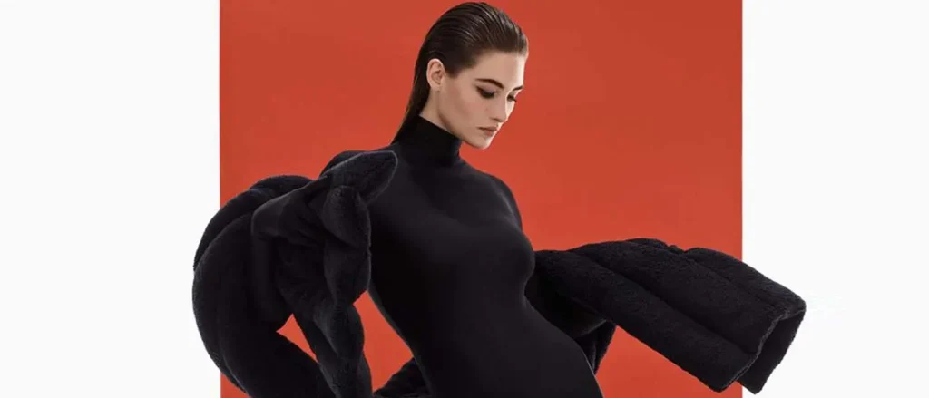 Modelo con vestido negro en fotografía lookbook de moda con fondo rojo en Bogotá